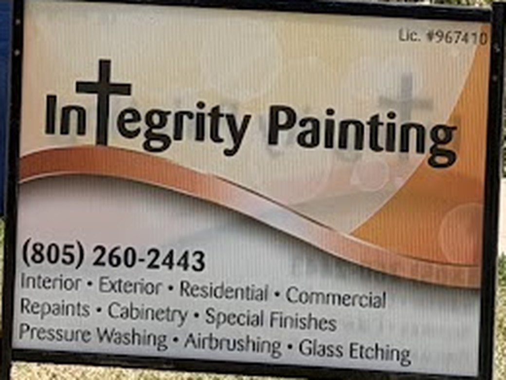 Integrity Painting's yard sign on a lawn, printed with the phone number, a list of services and the licence number.